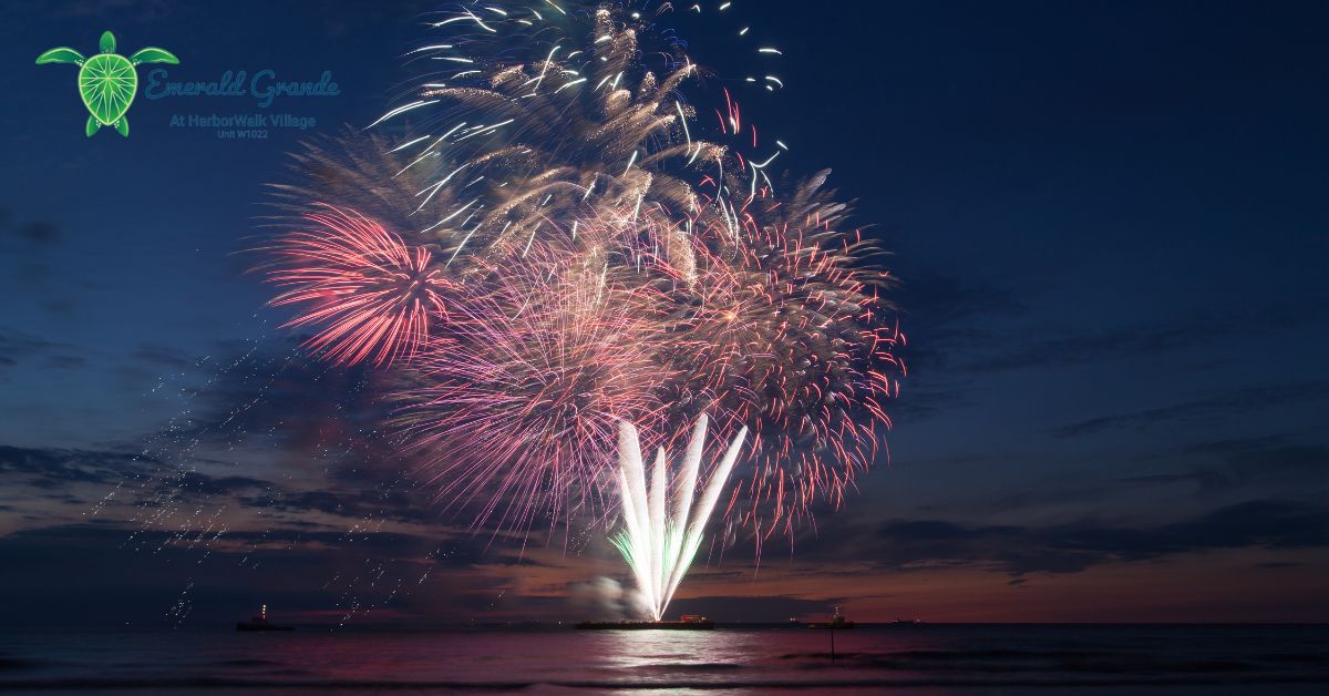Colorful fireworks lighting up the night sky over the water near Emerald Grande at HarborWalk Village in Destin, FL