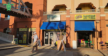 Gentleman walking by shops at HarborWalk Village in Destin FL