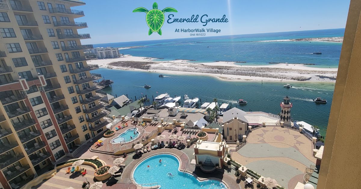 View of Emerald Grande resort pools, HarborWalk Village and Destin Harbor with emerald waters in Florida